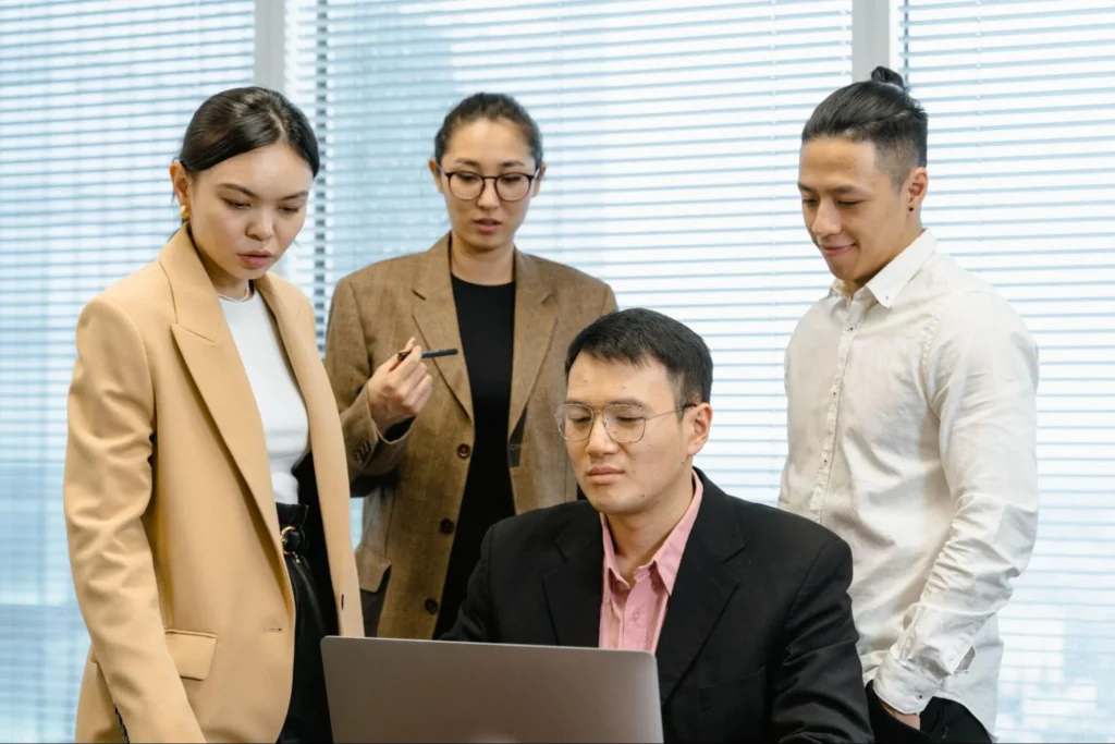 Offshore team reviewing work laptop office